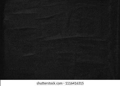 Black creased crumpled paper background texture surface old torn ripped posters grunge backdrop   
