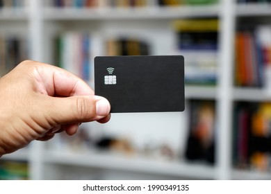 black credit or debit contactless card with contact less sign. Digital payment system.