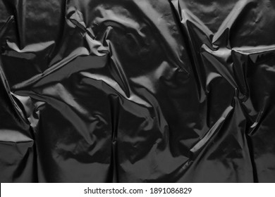 Black Crumpled Glossy Magazine Paper Texture Background. Black Creased Paper Poster.