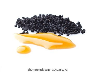Black cumin oil with seeds on white background - Shutterstock ID 1040351773