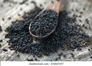 Black Cumin On Wooden Surface