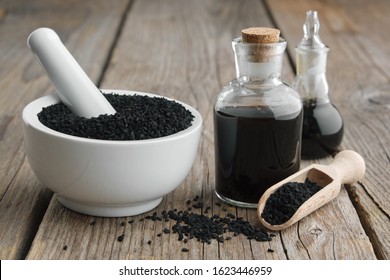 Black Cumin Or Roman Coriander Seeds And Black Caraway Oil Bottles. Ingredients For Cooking. Ayurveda Treatments.