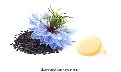 Black cumin seeds with flower and drop oil on white background - Shutterstock ID 1938476377