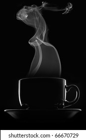 Black Cup Of Coffee With Steam On Black Background.