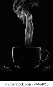 Black Cup Of Coffee With Steam On Black Background.