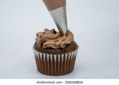 Black Cupcake Decorated With A Piping Bag Chocolate Cream