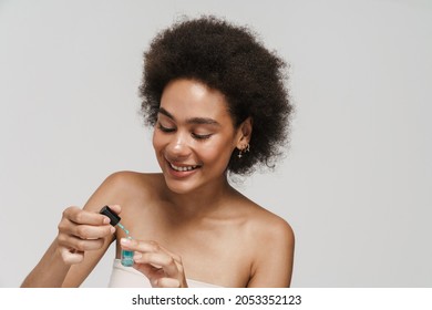 Black Curly Brunette Woman Smiling While Applying Nail Polish Isolated Over White Background