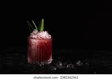 Black Currant Cocktail, with Pineapple slices and leaves for garnish. Crushed ice, black background and copy paste space