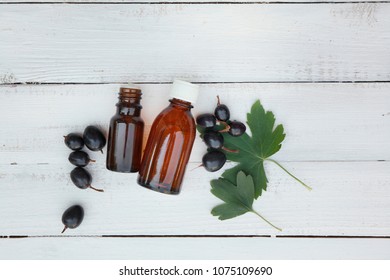 Black Currant Extract (oil, Tincture, Remedy, Infusion) Bottle On White Wooden Background