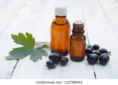 Black Currant Extract (oil, Tincture, Remedy, Infusion) Bottle On White Wooden Background