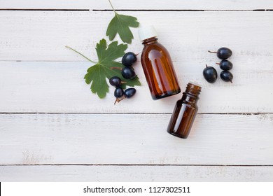 Black Currant Extract (oil, Tincture, Remedy, Infusion) Bottle On White Wooden Background