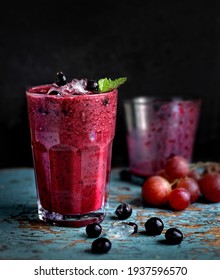 Black Currant Smoothie In Glassful On Dark Background