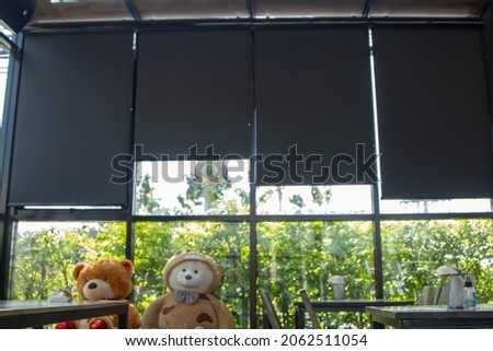 Black curtains or roll blinds on the glass window