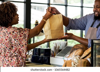 Black customer buying bakery products - Powered by Shutterstock