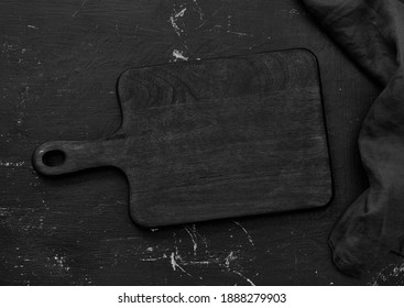 Black cutting board and black table cloth on black table - Powered by Shutterstock