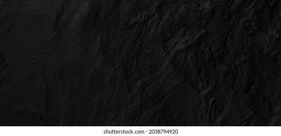 Black, dark abstract rock texture, interior for display products,stone wall background with copy space for design.