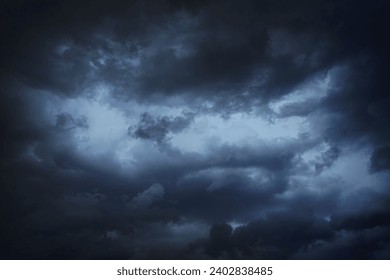 Black dark blue gray sky with heavy clouds. Dramatic background. Storm hurricane wind rain cloudy. Ominous scary creepy. Gloomy atmosphere. - Powered by Shutterstock