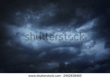 Black dark blue gray sky with heavy clouds. Dramatic background. Storm hurricane wind rain cloudy. Ominous scary creepy. Gloomy atmosphere.