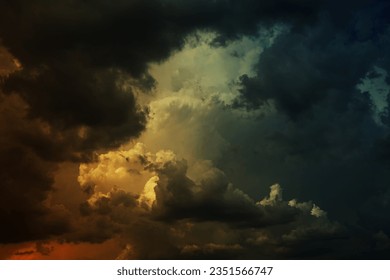 Black dark green blue teal yellow orange red storm clouds. Dramatic ominous night sky background. Hurricane wind cloudy rain lightning glow fire. Epic fantasy mystic. Or war horror apocalypse concept.