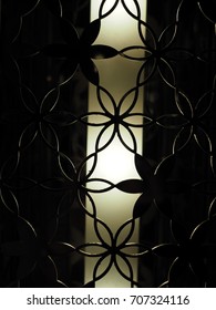 Black Dark Iron Steel Wire Grill Grid Art, See Through Flower Shape, With Yellow Long Lamp Inside The Cage, Abstract