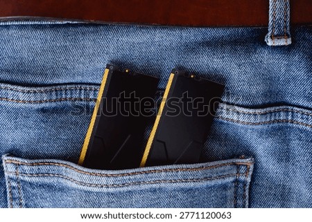 Black DDR5 RAM memory modules placed inside a jeans pocket. RAM shortages on the market, rising prices, and increased demand driven by the growing need for AI training.