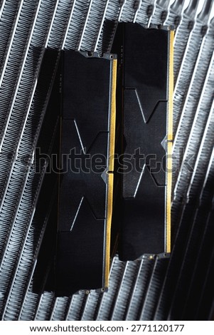 Black DDR5 RAM memory modules placed on a aluminum radiator. RAM shortages on the market, rising prices, and increased demand driven by the growing need for AI training.