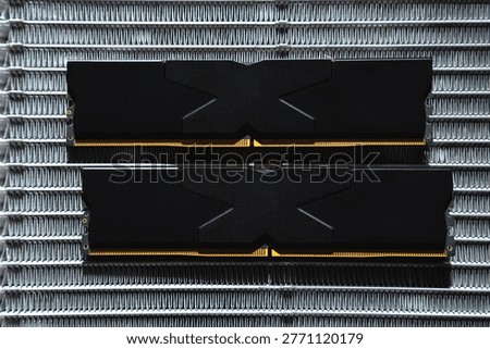 Black DDR5 RAM memory modules placed on a aluminum radiator. RAM shortages on the market, rising prices, and increased demand driven by the growing need for AI training.