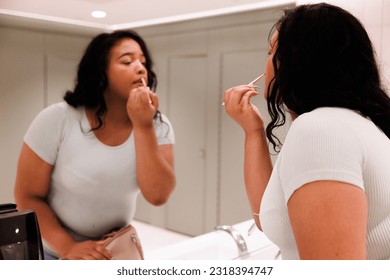 A Black, deaf, transgender woman using an all inclusive, accessible bathroom Stock Photo