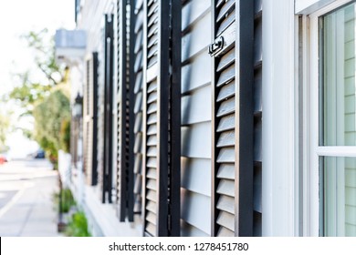 Black decorative row of window shutters closeup architecture open exterior of houses buildings or homes in Charleston, South Carolina southern city - Powered by Shutterstock