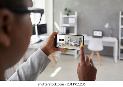 Black designer taking office interior photos, making presentation or video calling client using smart phone app. Rental agent or realtor shows work space while giving tour around display apartment - Shutterstock ID 2011911236
