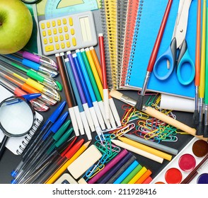 Black Desk's Surface Covered With Multiple Stationery Office Supplies As A Background Back To School Composition, Top View Above