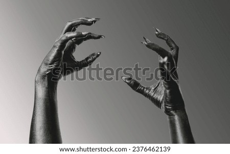 Black Devil Creepy Scary Monster Halloween Hand isolated on a grey background. Concept of murder. Horror Scene with Bloody Hand. closeup Black Hands with Long Nails death. Creepy monster claw. violanc