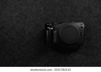 Black digital camera. Camera in hands. Camera on black background. Gray background. Modern technologies. Photographer. Camera body. Lens