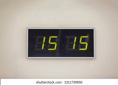 Black digital clock on a white background showing time fifteen hours fifteen minutes - Powered by Shutterstock