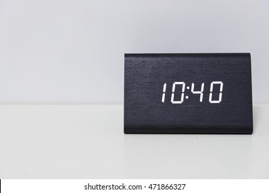 Black digital clock on a white background showing time 10:40 (ten hours forty minutes)
