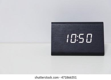 Black digital clock on a white background showing time 10:50 (ten hours fifty minutes)
