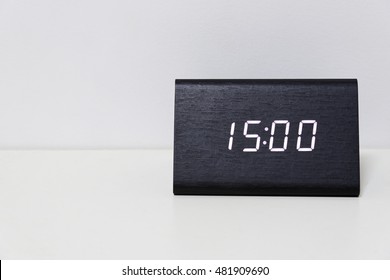 Black digital clock on a white background showing time 15:00 (fifteen hours) - Powered by Shutterstock