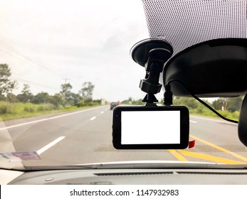 Black Digital Dashcam Camera  Installed In The Car Near The Rearview Camera Have Many Useful For Driver When Drive On The Road. 