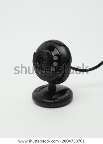 Black digital USB webcam with microphone and LED lights isolated on a white background.