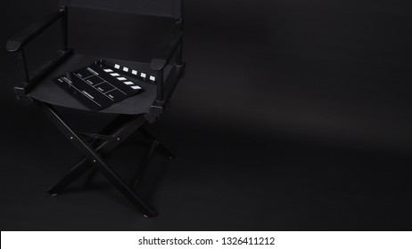 Black  director chair with Clapper board or clap board or movie slate use in video production ,film, cinema industry on black background.