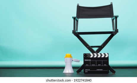 Black director chair with megaphone on green or Tiffany Blue or mint background.it use in videography or film cinema industry