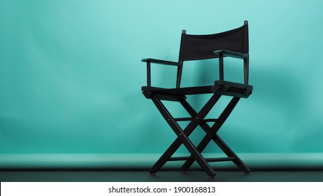 BLACK  director chair on green or Tiffany Blue and black floor background.it use in video production or movie and cinema industry. 