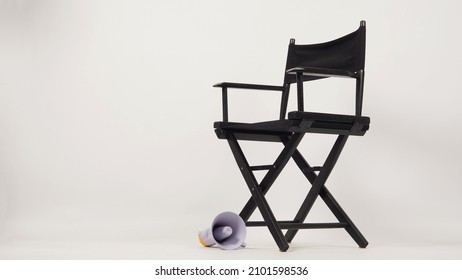 Black Director Chair And Yellow Megaphone On White Background.