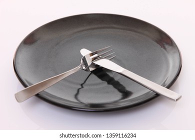 Black Dish On The White Table With Cutlery Meaning That Was No God