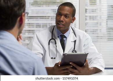 Black Doctor With Patient And Using Electronic Tablet, Horizontal