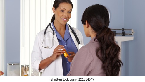 Black doctor talking to female patient about new prescription