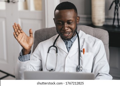 Black Doctor Using Laptop To Communicate With A Patient. Smiling Male African American Professional Young Doctor. 