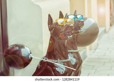 Black Dogs Mannequins. Funny Big Dogs In Bright Blue And Yellow Glasses And Sun Glare. Toned Photo
