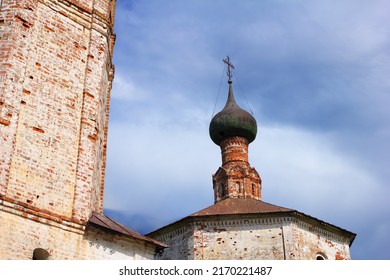 Black dome and cross, peeling brick walls of old abandoned russian Orthodox Church of Cosmas and Damian at the background of stormy sky with dark clouds in Suzdal, Vladimir region, Russia, Europe