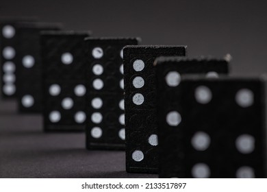 Black Dominoes on dark background, Closeup scattered dominoes on a gray, table. Board game, Game night Dominos table game.